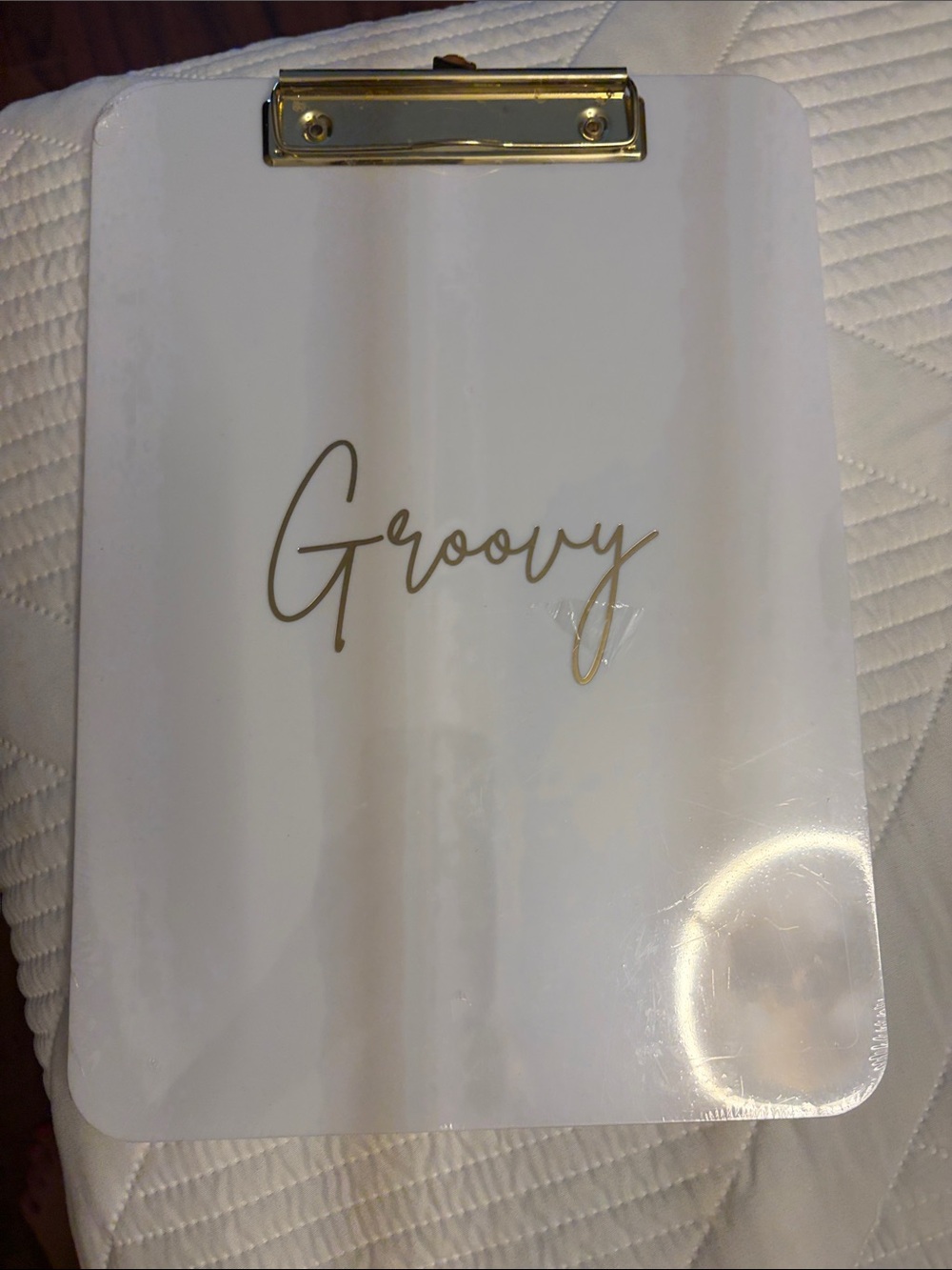 White Clipboard with Gold "Groovy" Script